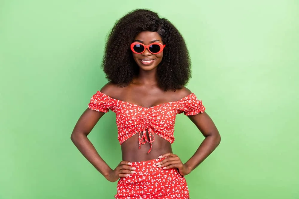 150% vs. 180% Density Curly Wig: Is 180 Density Better Than 150? 3 A millennial female that often wears medium-density wigs is wearing a lace front wig with long hair.
