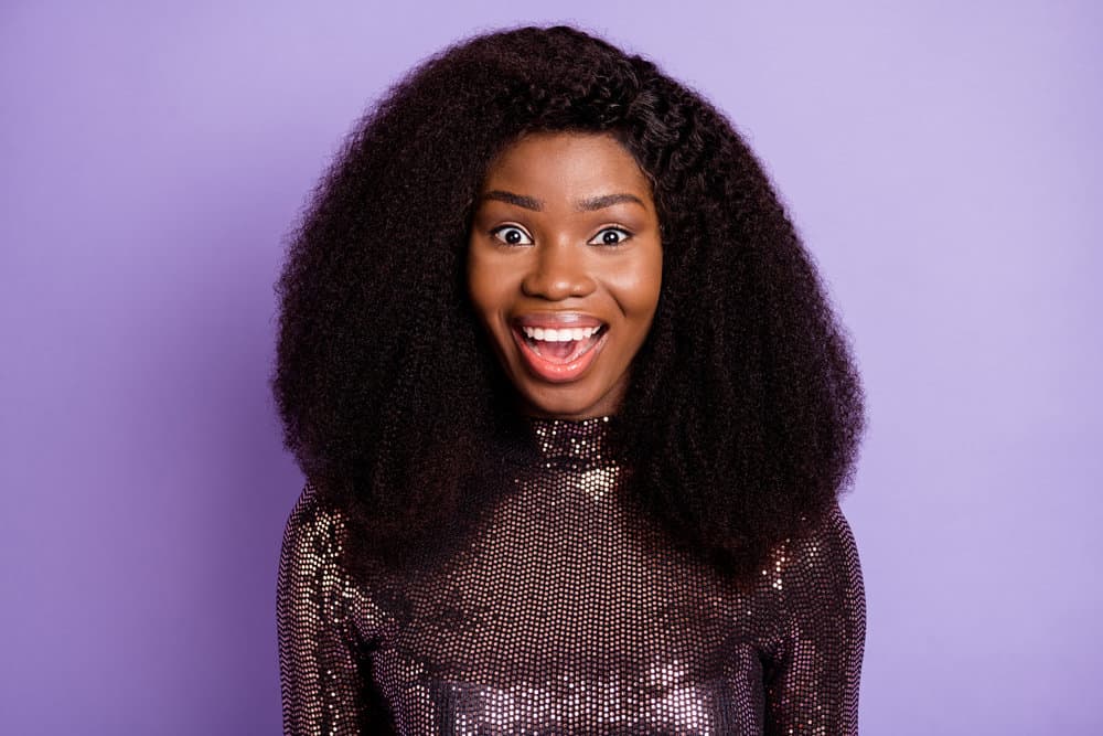 What Is a Wig Closure? Lace Closure Wig vs. Lace Frontal Wig 1 A black woman wearing a lace closure wig made from human hair using a flat and seamless installation.