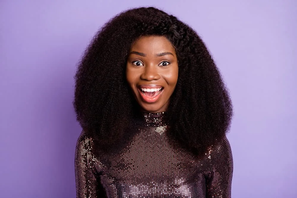 What Is a Wig Closure? Lace Closure Wig vs. Lace Frontal Wig 1 A black woman wearing a lace closure wig made from human hair using a flat and seamless installation.