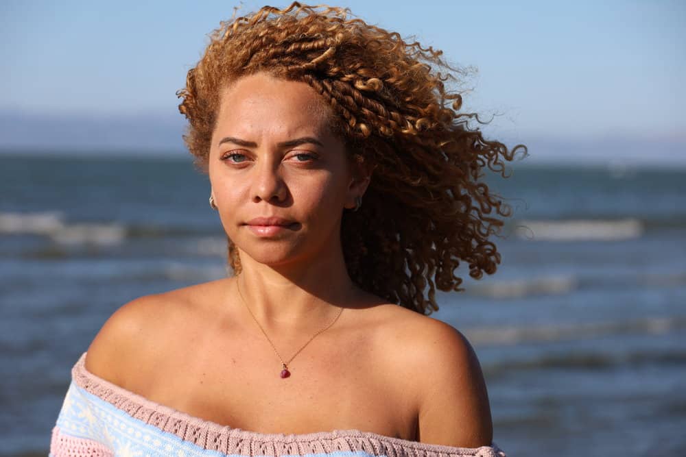 A cute Brazilian female with unwanted orange tones on her natural platinum blonde hair color.