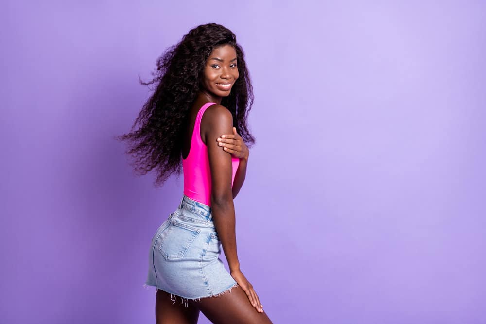 An adorable young black girl wearing a breathable wig covering her own hair and creating a natural scalp.