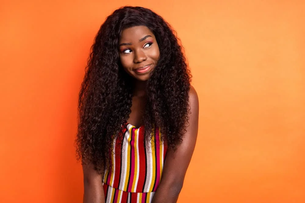 Is 150% Density Good for a Wig? How Thick Is a 150% Density Wig? 7 A cure black girl woman that often wears low-density wigs to change up her style and have more hair than normal.