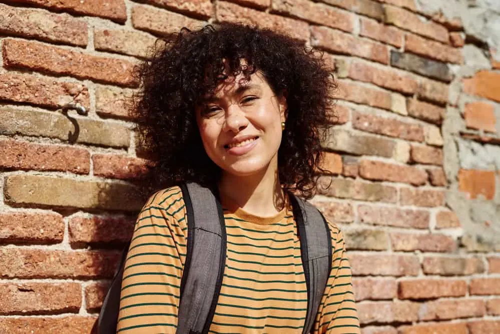 How to Clarify Curly Hair at Home: DIY Clarifying Guide 12 A gorgeous young lady with damp hair that was recently washed with an essential moisture baby shampoo.