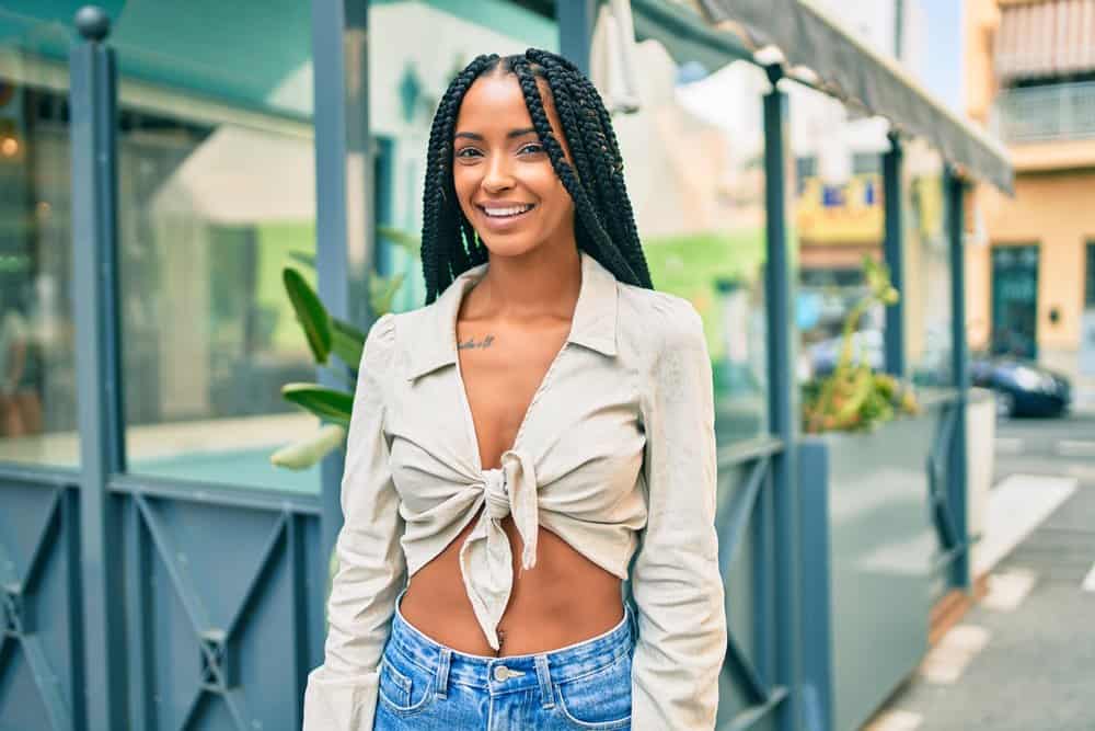 African American woman with natural curls wearing Marley twists to add volume to her natural texture.