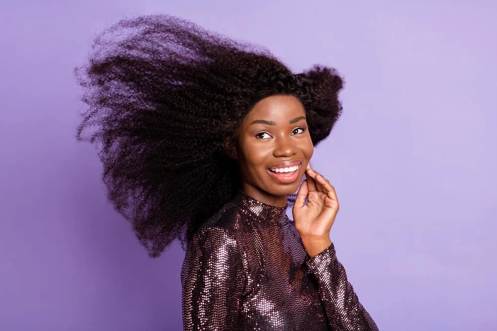 What Is a Wig Closure? Lace Closure Wig vs. Lace Frontal Wig 5 A black girl with dark brown natural skin wearing a wig with a silk closure using a full and flawless install.