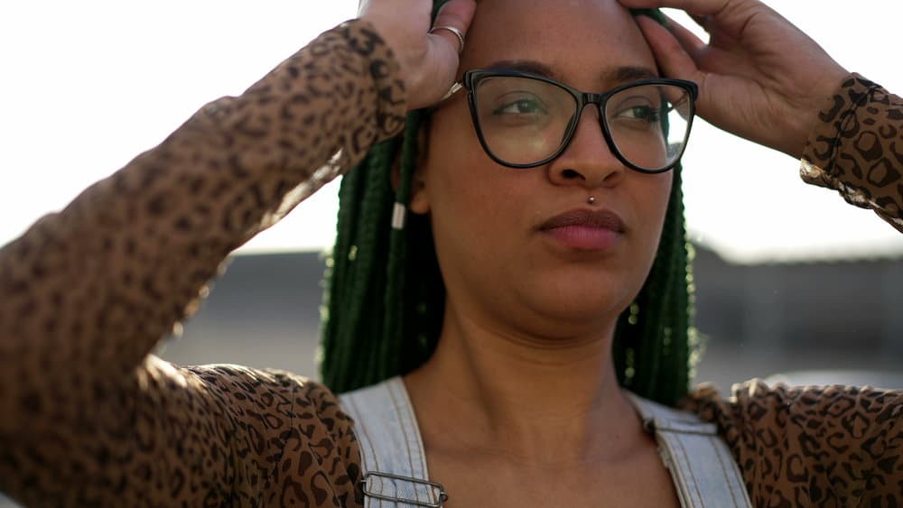 A cute young woman that used a spray bottle ("braid spray") with medicated shampoo to clean her scalp.