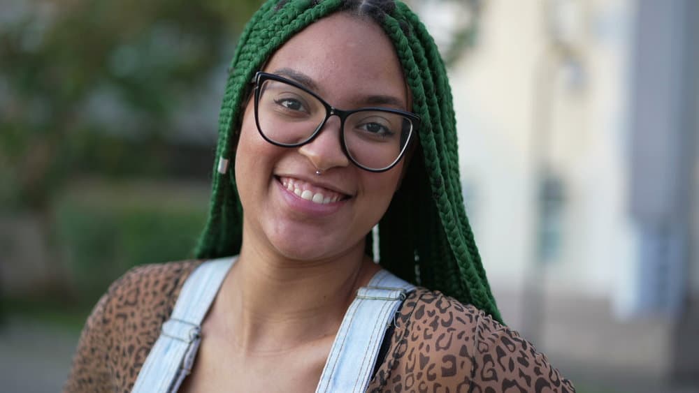 A young woman with neat braids experienced scalp itching with coconut oil, olive oil, and a few drops of tea tree oil.