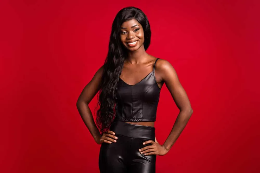How Long Does Wig Glue Last? How to Make It Last Longer 2 African American female that likes to wear synthetic hair wigs is wearing a lace wig glued carefully to her own hair where the excess glue was wiped away.