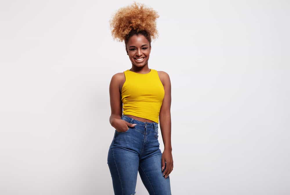 A black female with medium hair length just learned how to do the pineapple method on her natural hair.