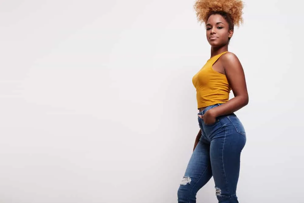 Pineapple Hair: How to Do a Pineapple Hairstyle on Curly Hair 7 African American female wearing a pineapple hairstyle secured with bobby pins after watching video tutorials.
