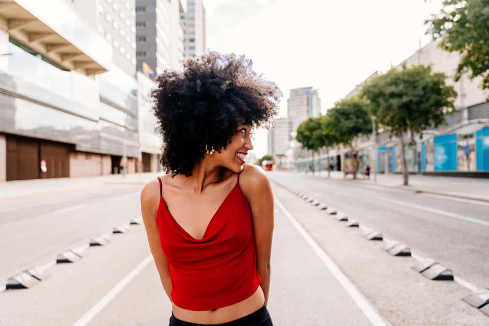 A black lady with freshly washed hair that was cleaned with a lower pH shampoo and homemade leave-in conditioner.