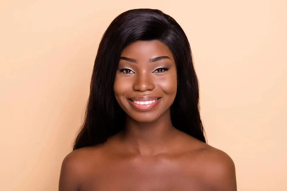180 Wigs: What Does 180% Density Wig Mean? How's It Look? 1 A charming young female wearing a 180% hair-density lace wig made of fine hair with a middle-back hair length.