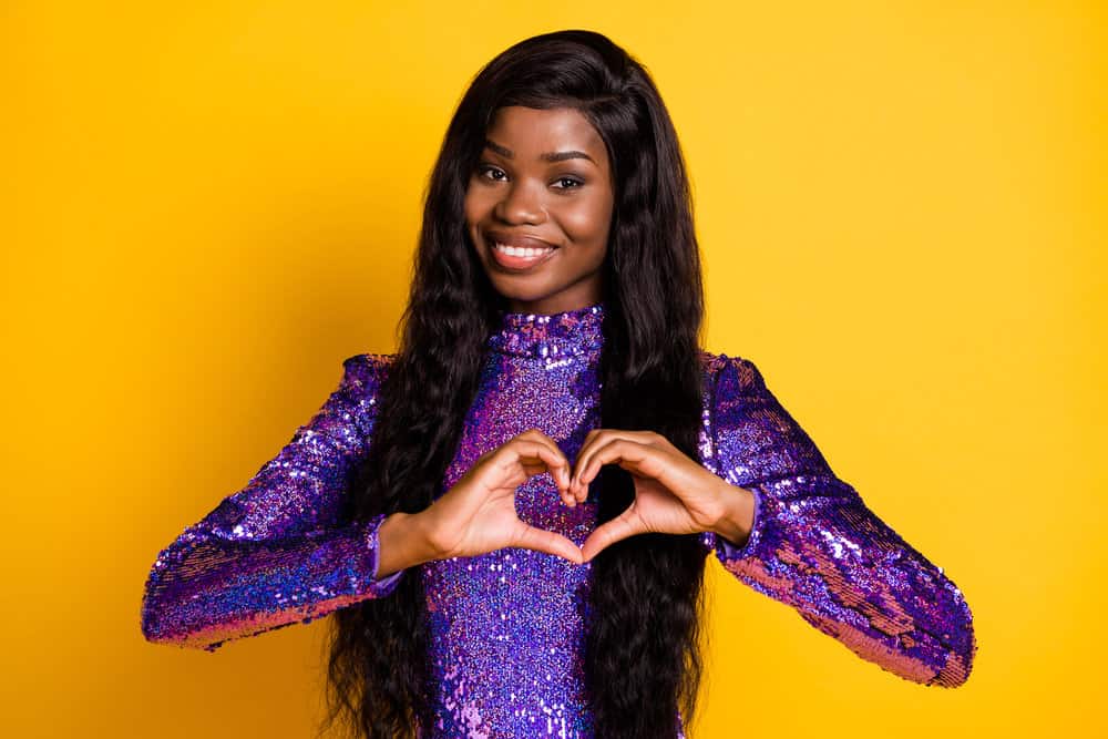 A black woman wearing a t-part lace wig cap made from virgin human hair creates a very natural hairline.