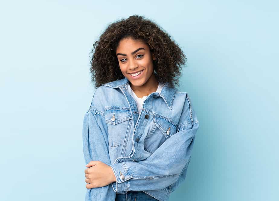 A black girl that uses peppermint essential oil to give her hair a refreshing scent.