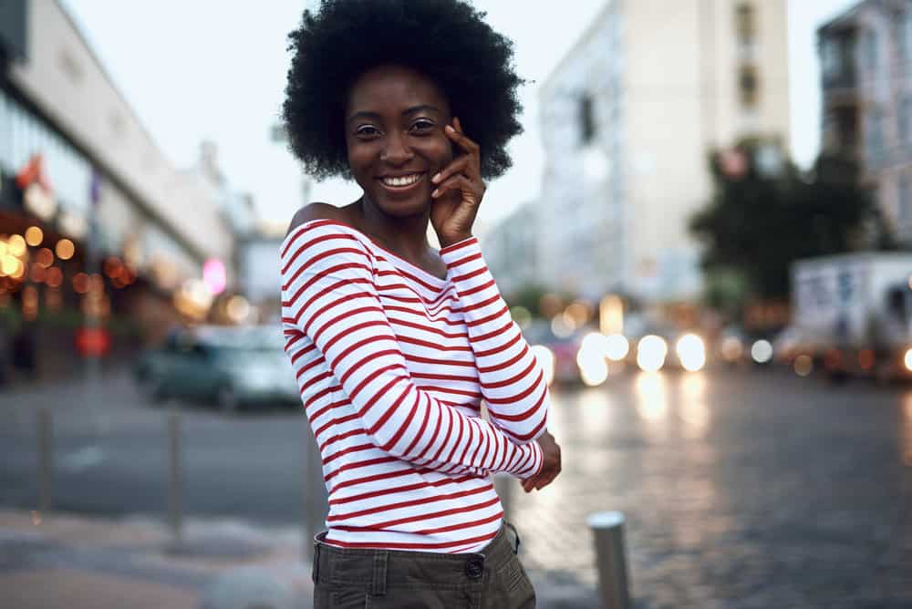 A dark-skinned black girl with 4C natural hair, completely clean after using co-wash products.