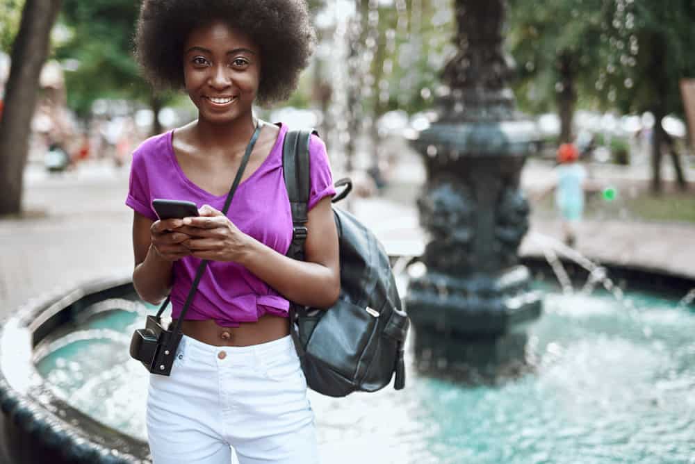 A beautiful black female wearing her hair stretched and styled with a leave-in conditioner.