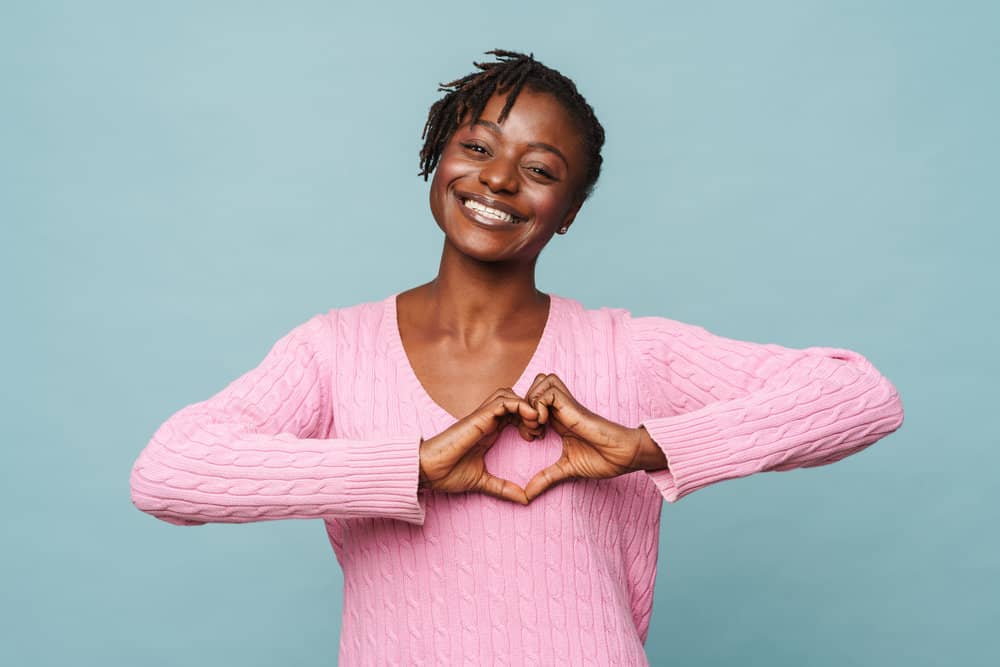 These stunning baby locs worn by a black female were achieved through keep her shorter hair moisturized to encourage hair growth and thicker locs.