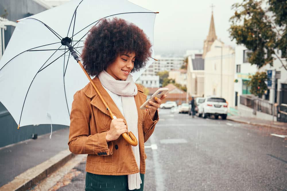 A pretty black female reading about how to mix flaxseed gel to make your hair healthier.