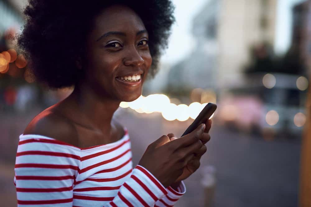 A black female with curly hair follicles after co-washing natural hair with a regular conditioner.