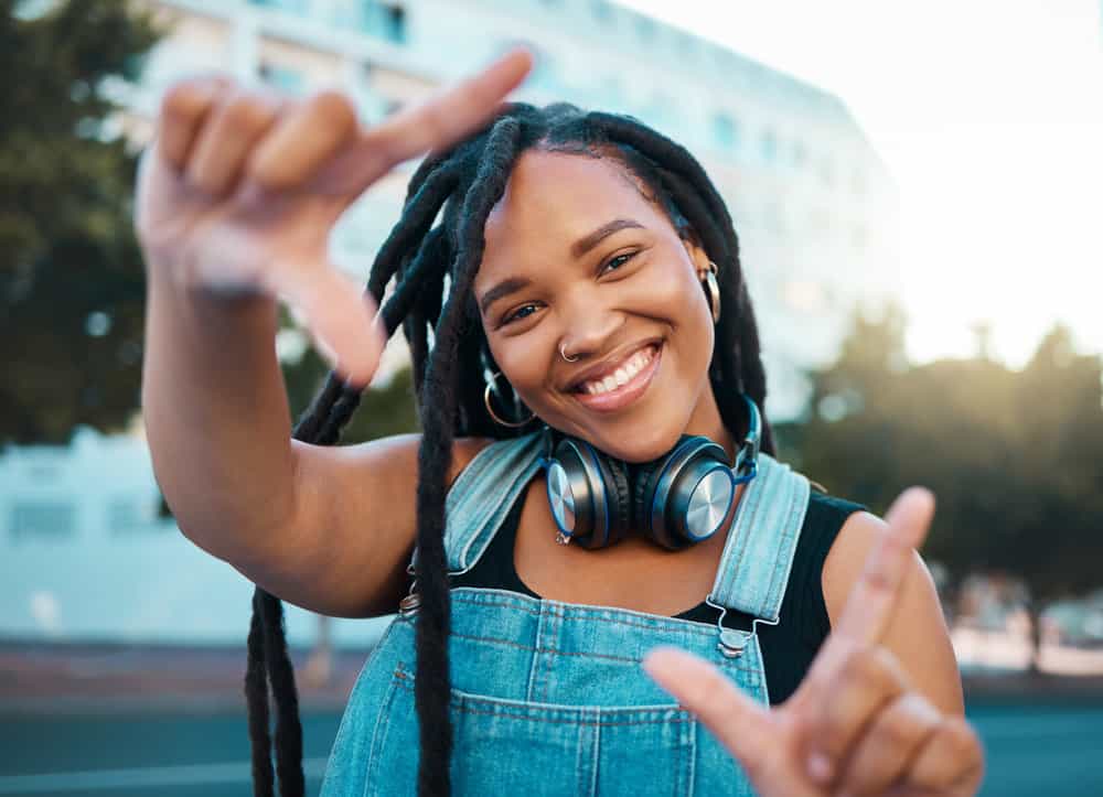 A black woman wearing adult locs started with two-strand twists is seeing good hair growth.