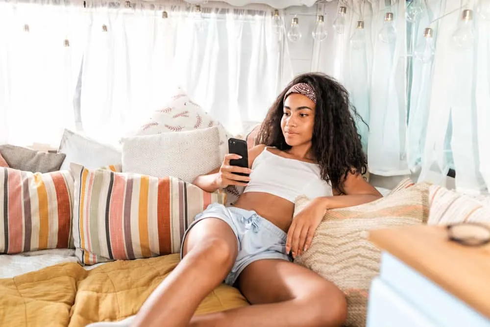 How to Use Clarifying Shampoo on Curly Hair: Step-By-Step 5 A beautiful black girl with hair cuticle damage on her textured hair follicles styled with coconut oil.