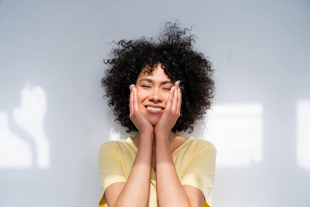 African American female washed her hair with a boiled rice water treatment made with brown rice grains.