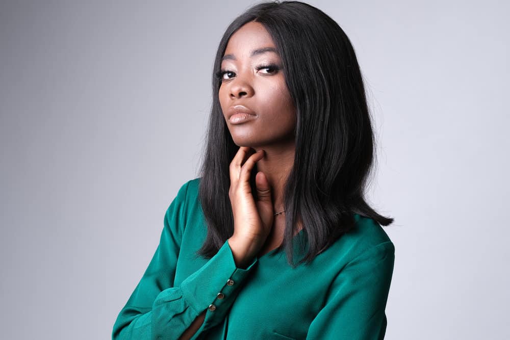 An African American female covered her baby hair ("edges") with a lace front wig made from human hair.