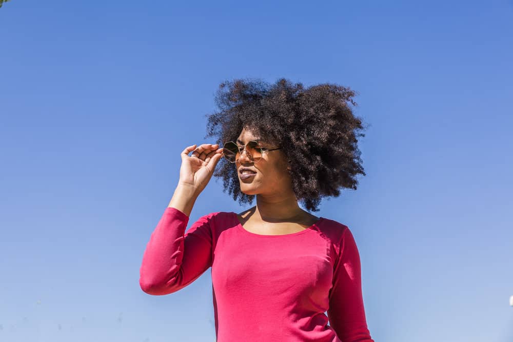 An attractive young female with a mid-back hair length cut her hair wet instead of when her hair was dry.