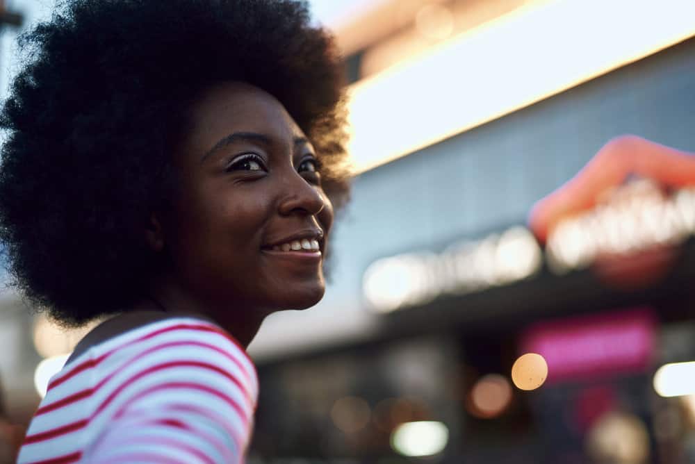 An attractive woman with high porosity hair after using a co-wash product to clean hair.