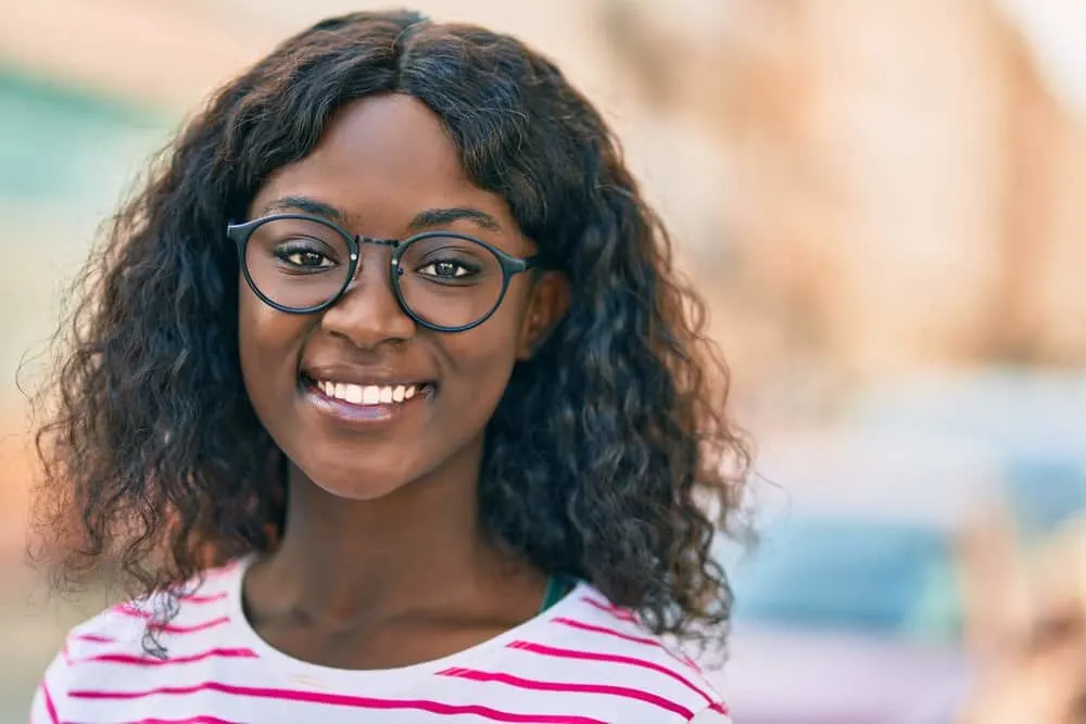 The black girl with fine hair wears a human head wig that has the same density as her natural hair.