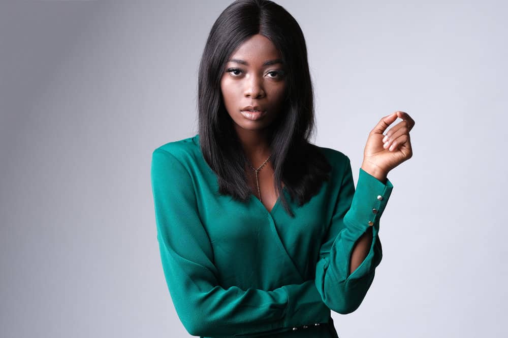 A stylish African American female with an HD lace wig secured with an elastic band.