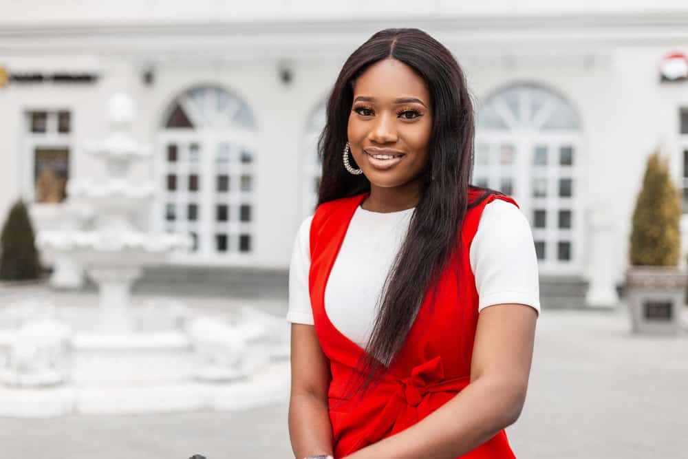 A young black female wearing a wig with an outre melted hairline made from premium synthetic fibers.