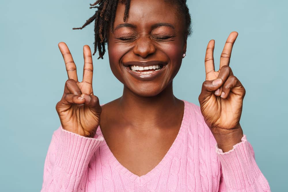 The black female's loc journey is represented beautifully after getting her hair twisted and treated with a deep conditioner.