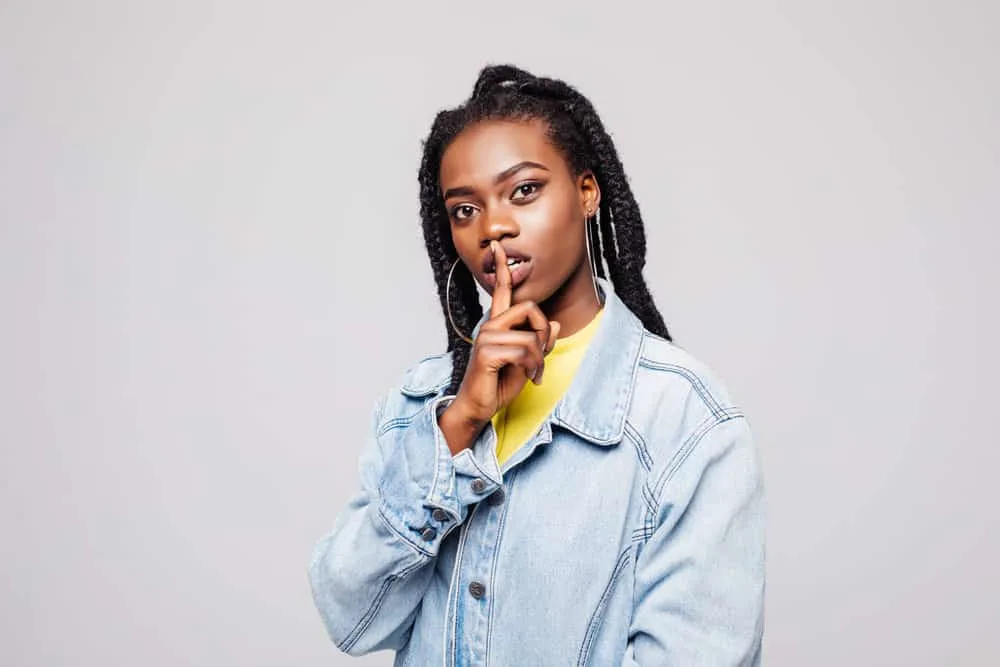 How to Braid Hair for Beginners: Braiding Types Step-by-Step 11 A beautiful dark skin black female wearing a creative double dutch braid hairstyle on her damp hair.