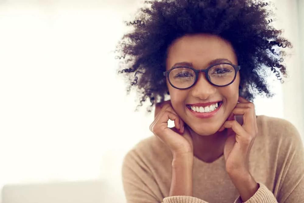 How to Get Rid of Frizzy Curly Hair in 5 Minutes at Home 1 A cute black female with frizz-free hair used a microfiber towel to remove excess moisture from her 4A curl pattern.