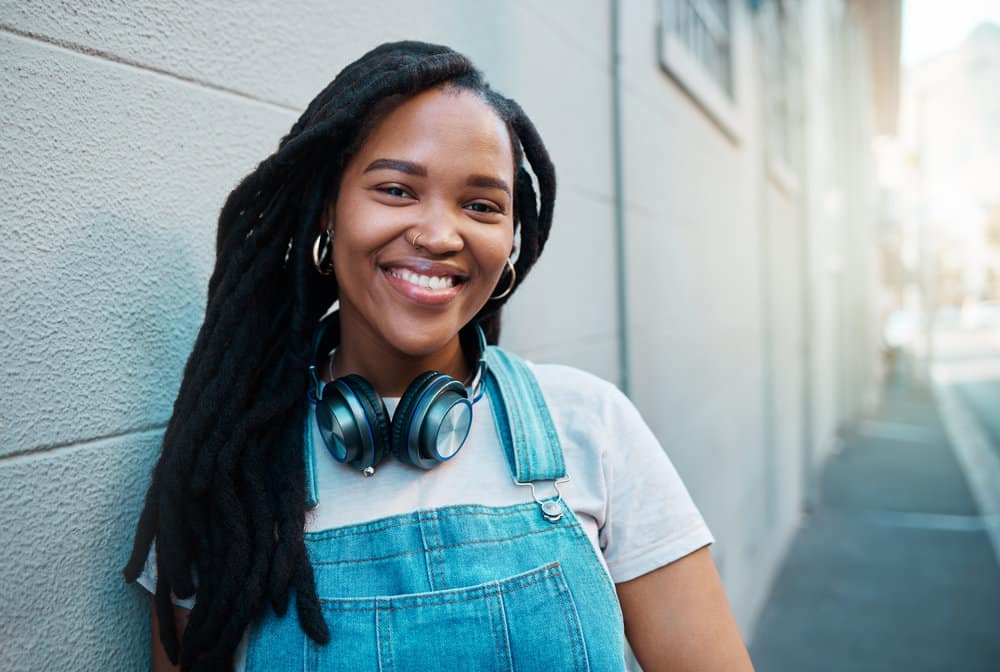 A fashionable African female is wearing her hair naturally in a lock style in the maturity phase.