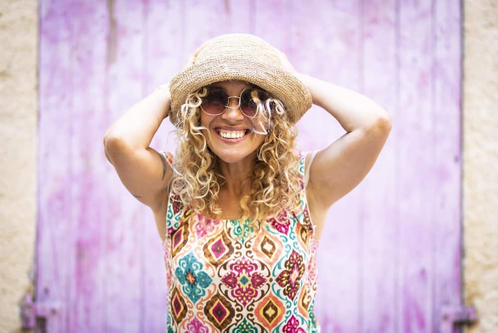 An enthusiastic young white lady toned her platinum blonde curls with YouTube videos.