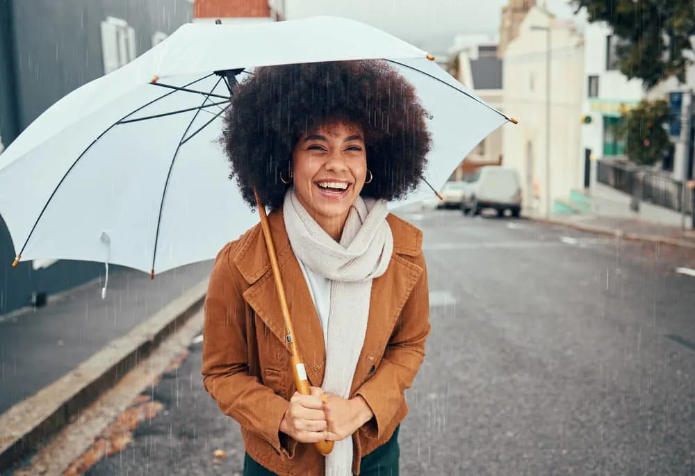 How to Use Flaxseed Gel for Curly Hair: DIY Hair Gel for Curls 4 A black woman outside on a rainy day showed off her beautiful hair growth with a wash-n-go hairstyle.