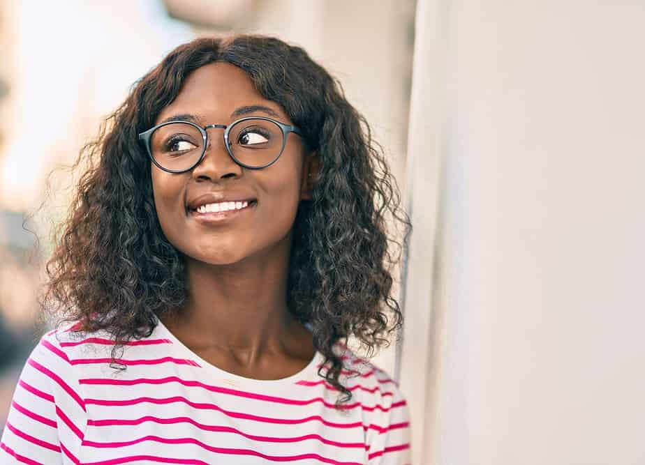 A dark-skinned black girl with an average human head wearing a standard hair density wig.