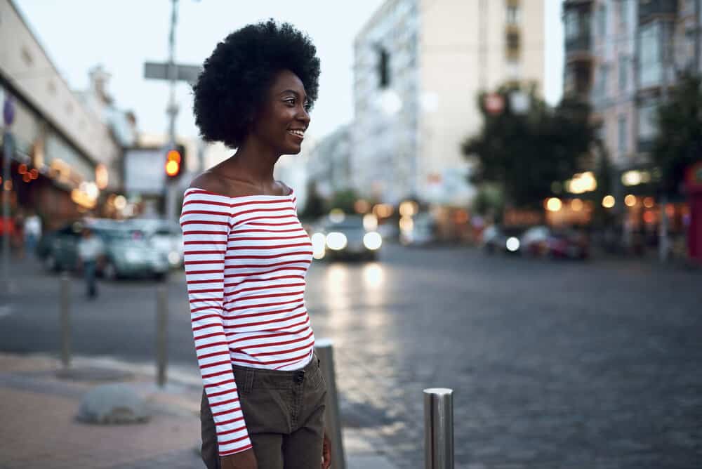 A black girl with a wash-n-go hairstyle uses a curly girl natural hair routine for 4C hair types.