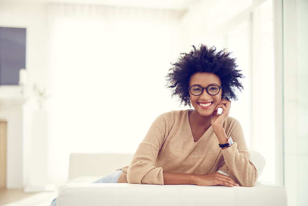 A beautiful curly girl looking to tame frizzy hair and create bouncy curls with jojoba oil.