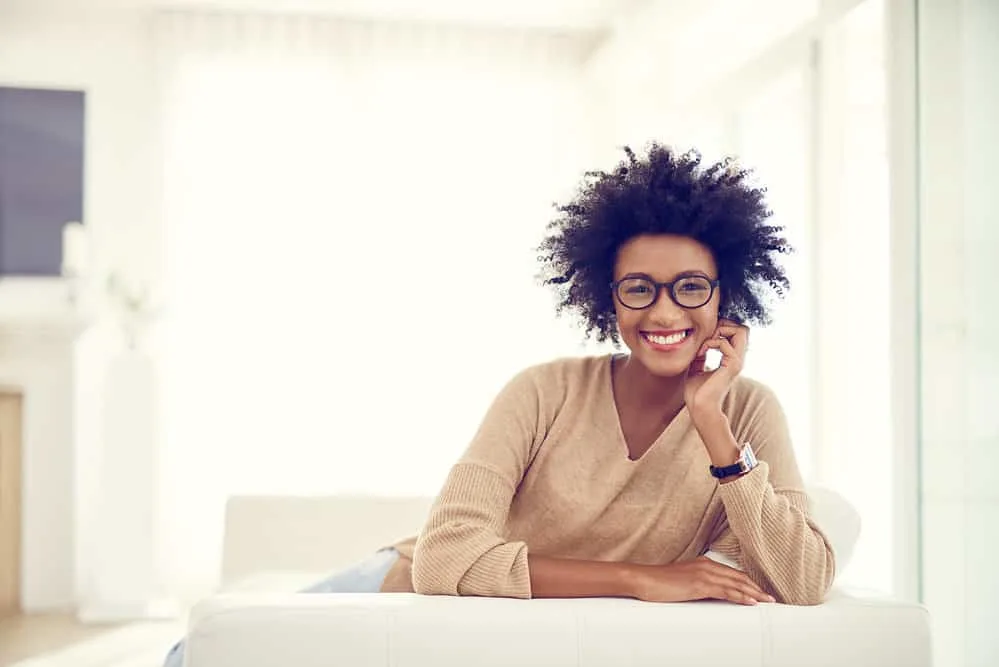 How to Get Rid of Frizzy Curly Hair in 5 Minutes at Home 2 A beautiful curly girl looking to tame frizzy hair and create bouncy curls with jojoba oil.