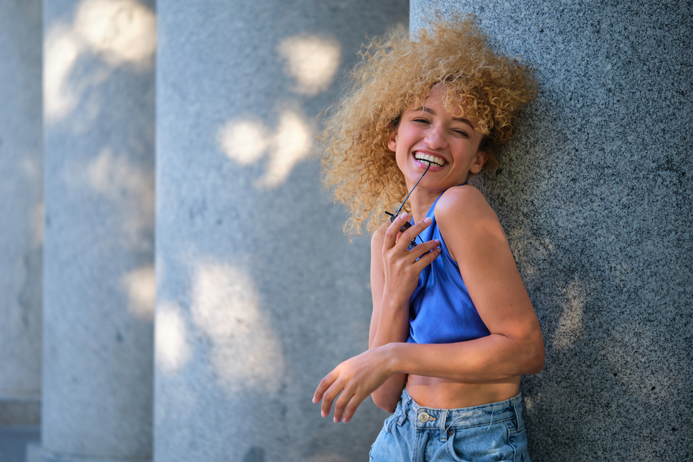 A beautiful black woman with a type 3 curl pattern has healthy hair without any split ends or sun damage.