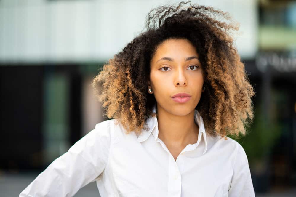 A cute black girl that used Shikakai for hair growth, hair lice, and to soothe her itchy scalp.