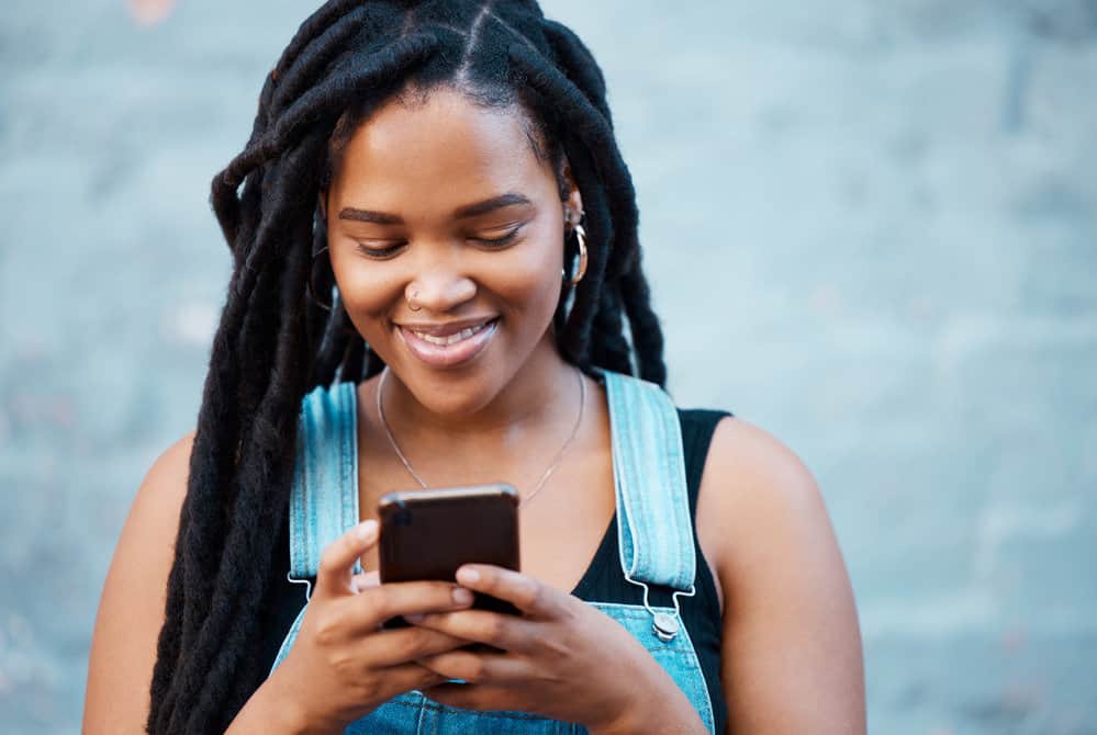 A black woman researching how to start locs from short hair for a close that loves her hair.