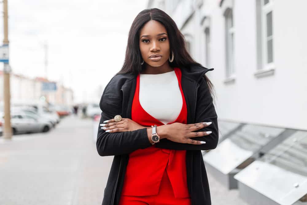 A lady with dark brown hair walked outside wearing a mid-back lace front wig length styled with a wide-tooth comb.