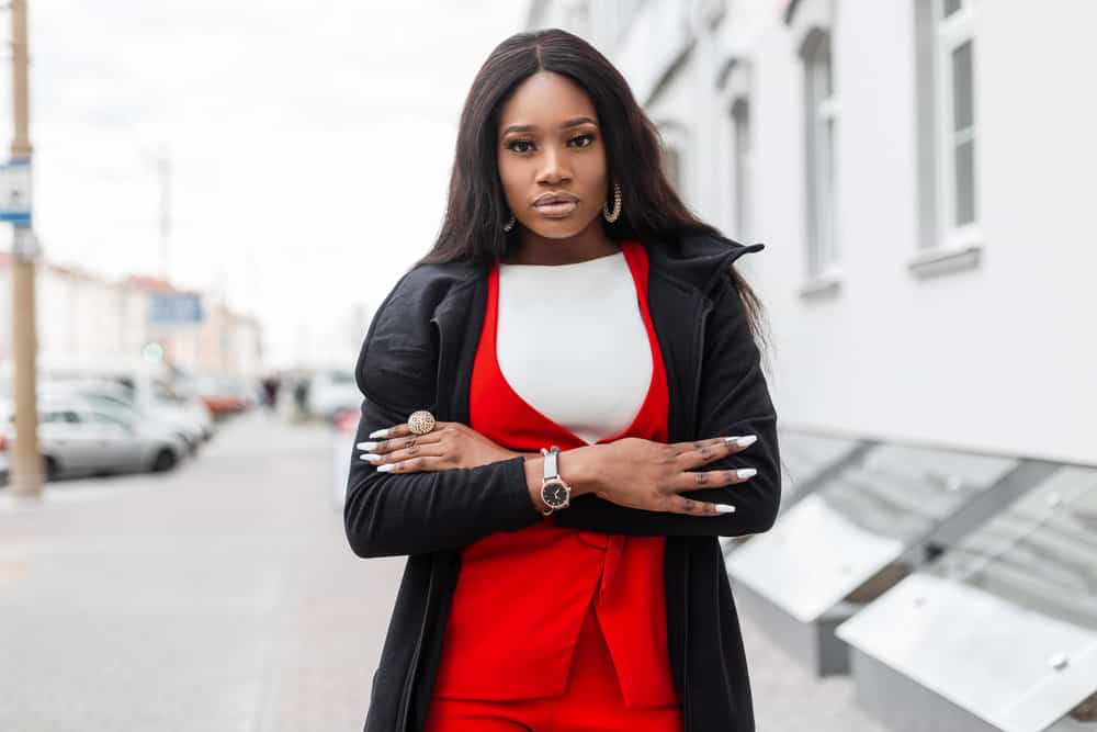 A lady with dark brown hair walked outside wearing a mid-back lace front wig length styled with a wide-tooth comb.