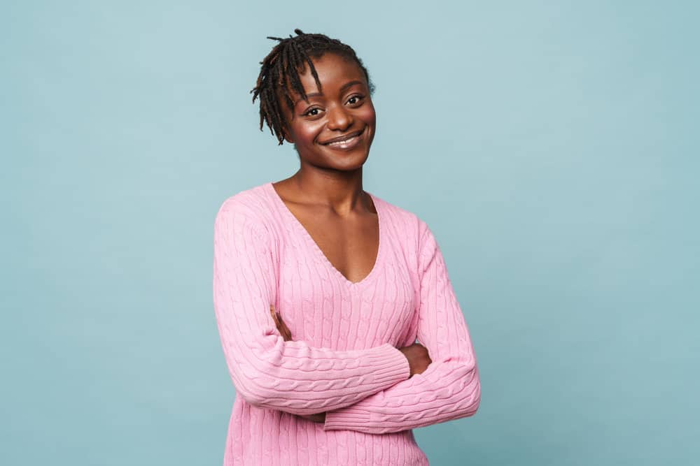 A black female's fine hair is beautifully represented by the loc extensions on her very short hair that was recently styled with the palm roll method.