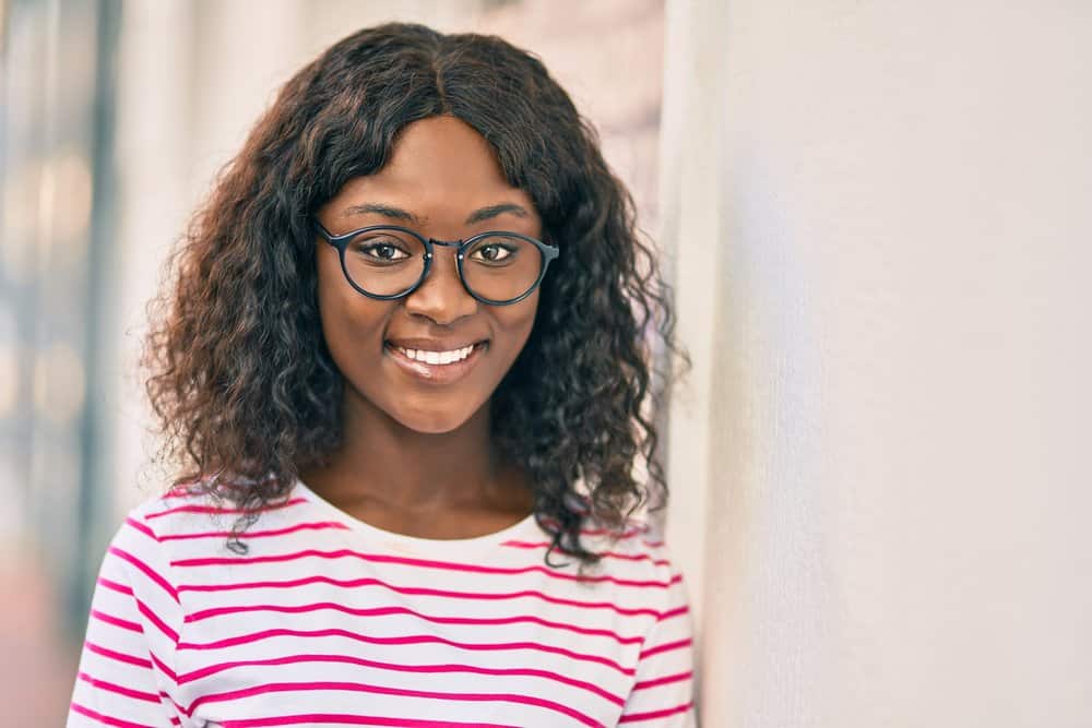 A young black woman that normally wears curvy and wavy hairstyles has a light-density texture.