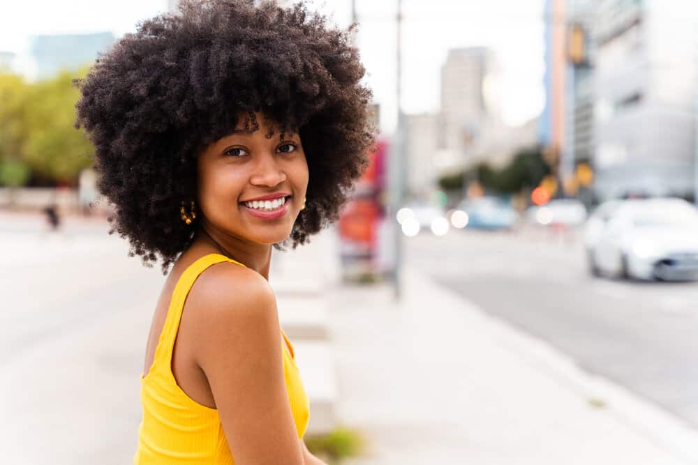 A beautiful black girl with damaged hair using the CG hair care method on her natural curls.